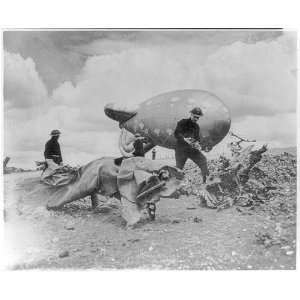  Crewmen inspect wreckage,flying bomb stopped by cable of 